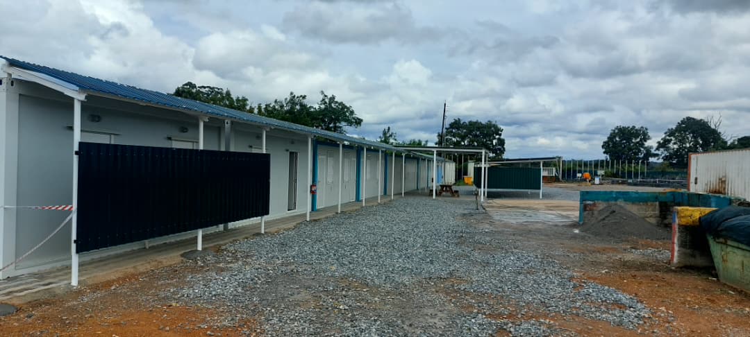 Row of modular accommodation units at a camp